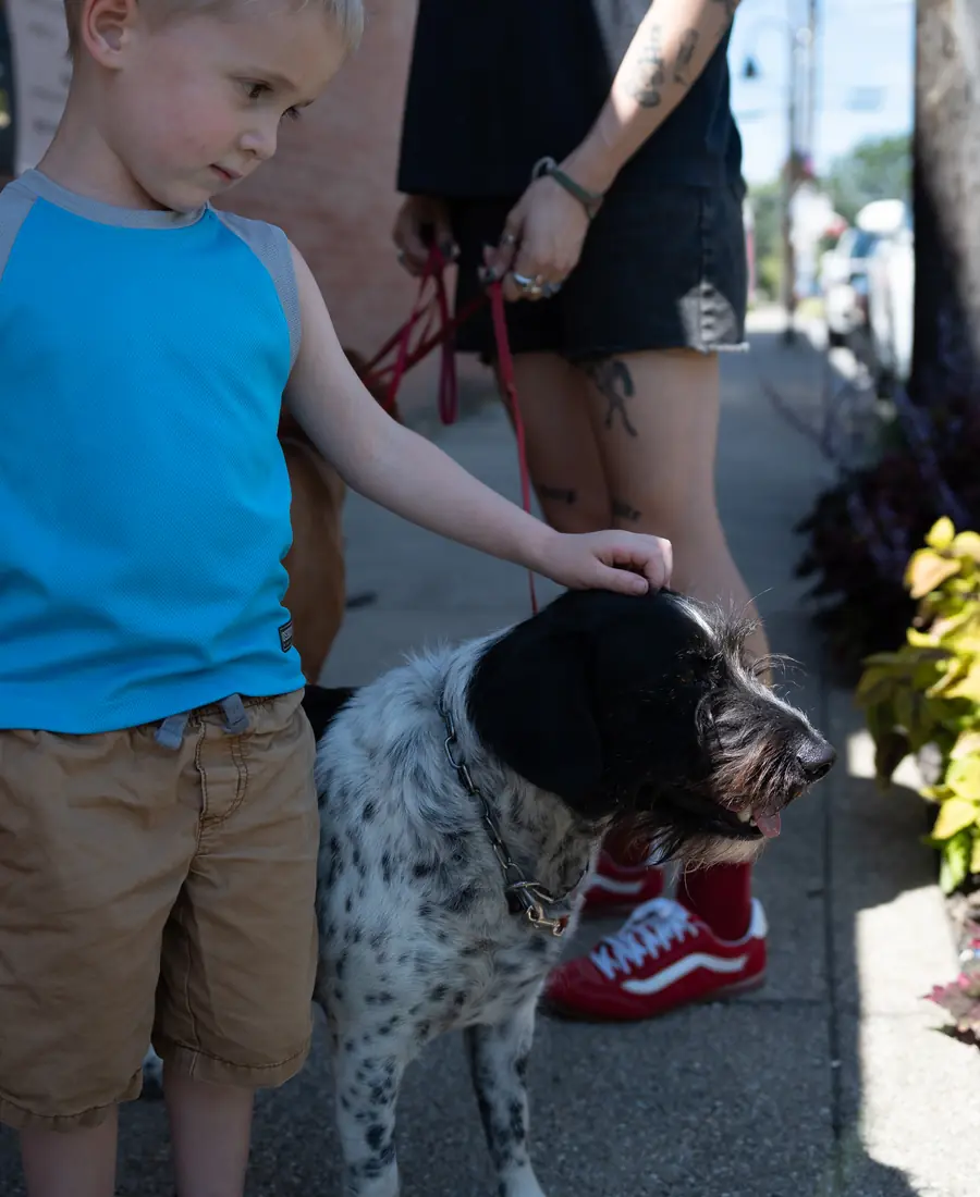 A child with a well-trained dog at Black Woof Inn in La Grange, KY